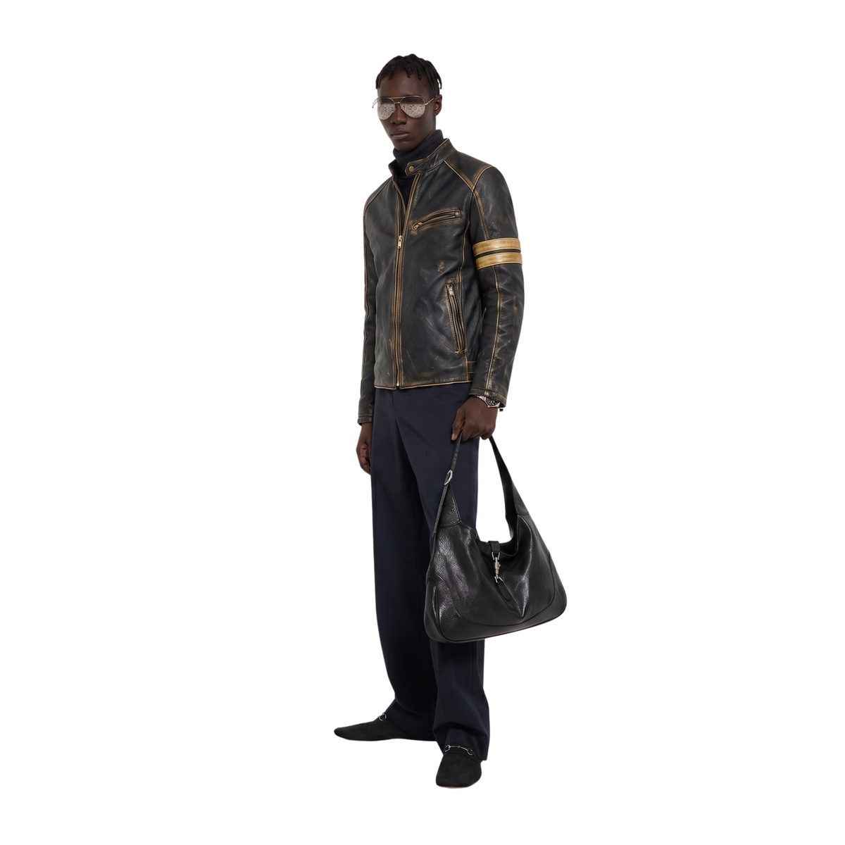 Men's distressed leather jacket with gold trim, paired with dark trousers and a black shoulder bag
