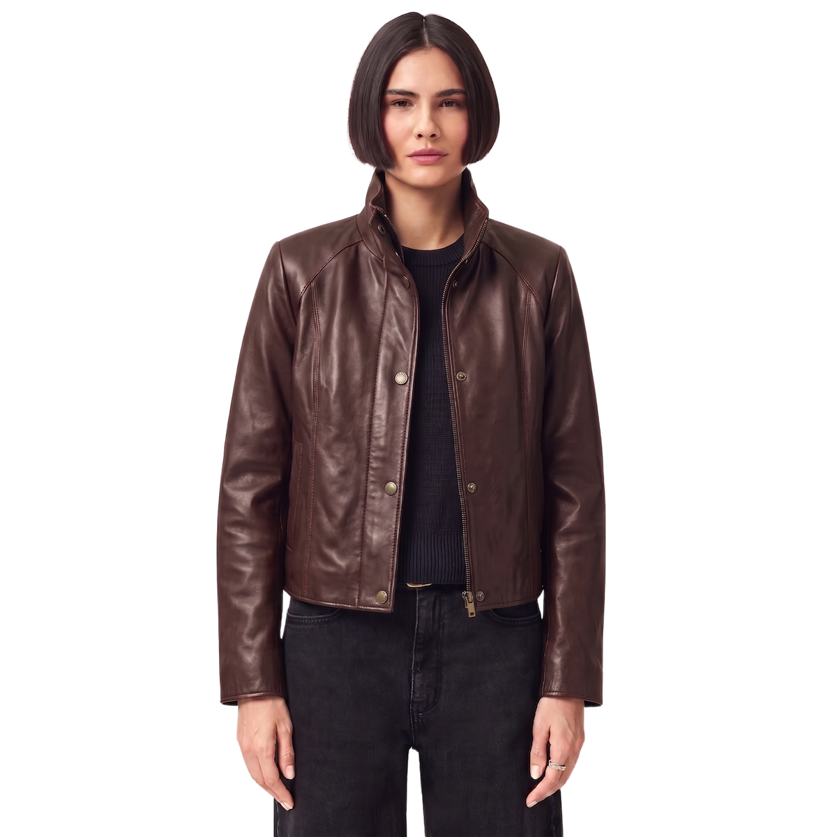 Brown leather jacket with zipper and button details, styled with black jeans and a knit top