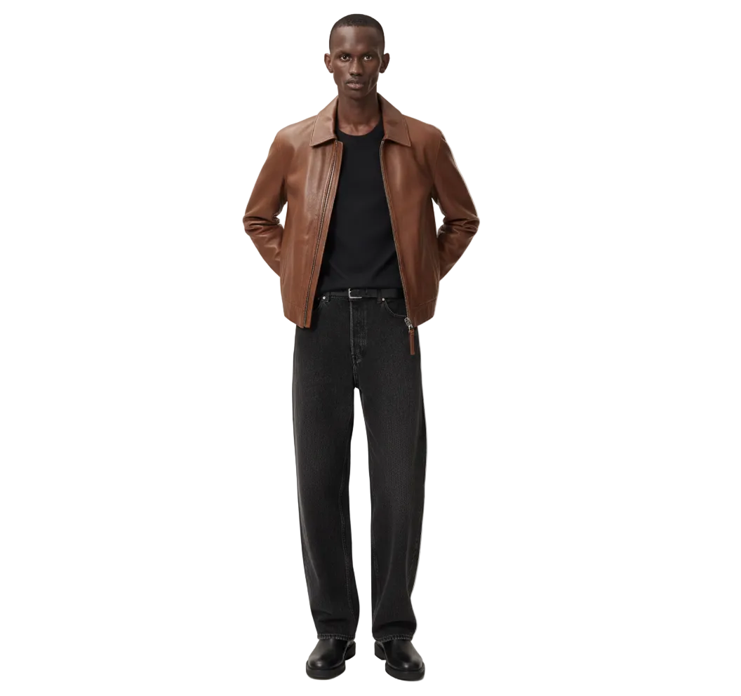 Man wearing brown leather jacket, black tee, and wide-leg jeans for casual style