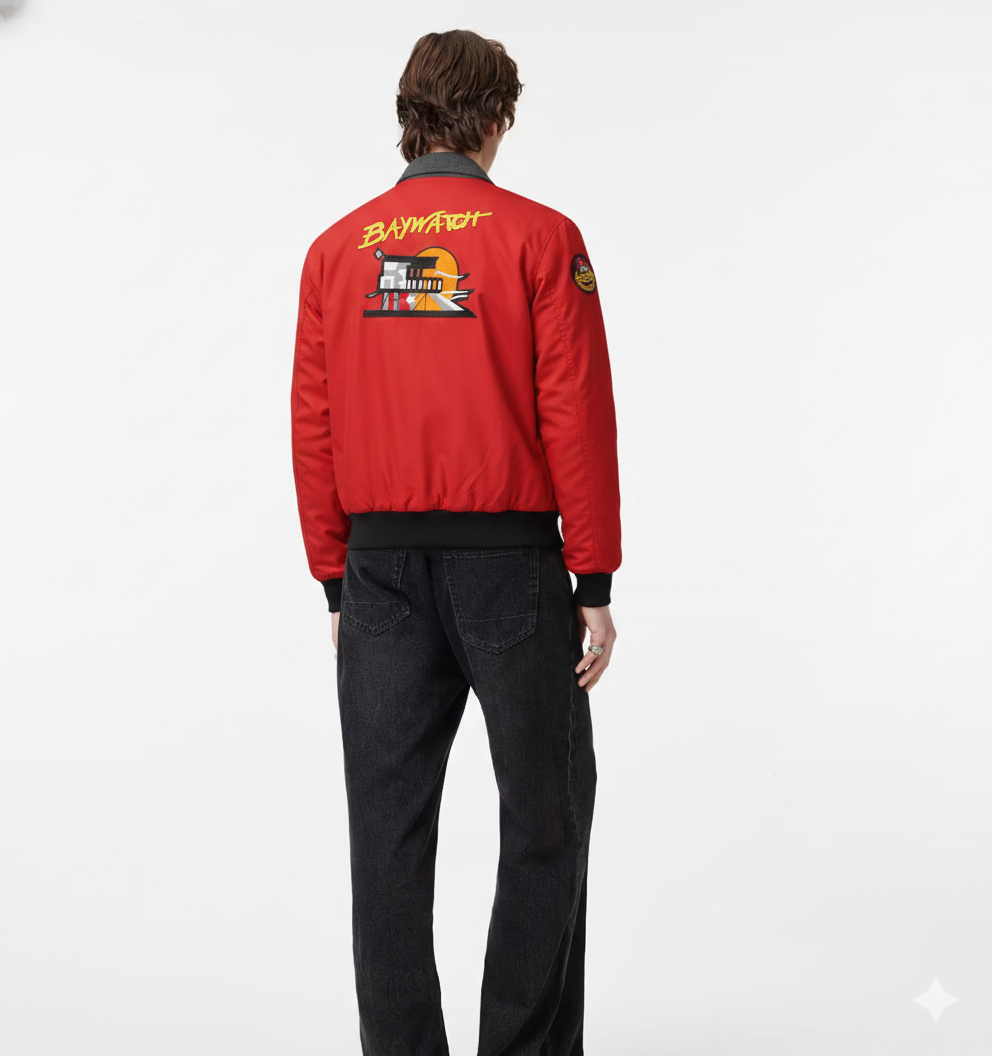 Red bomber jacket with Baywatch graphic on back, worn with black jeans