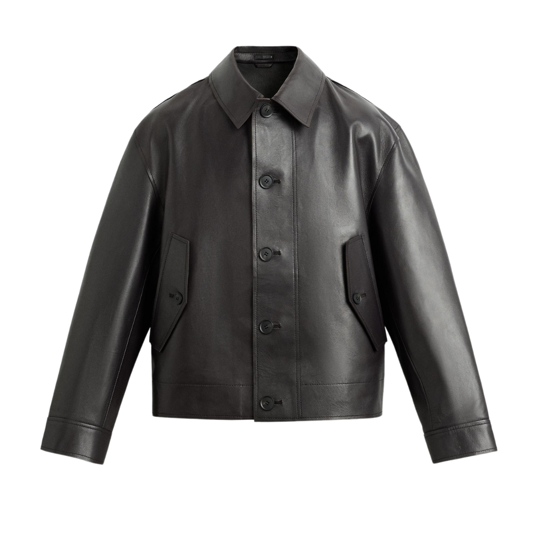 Black leather jacket with button front and flap pockets, sleek modern design