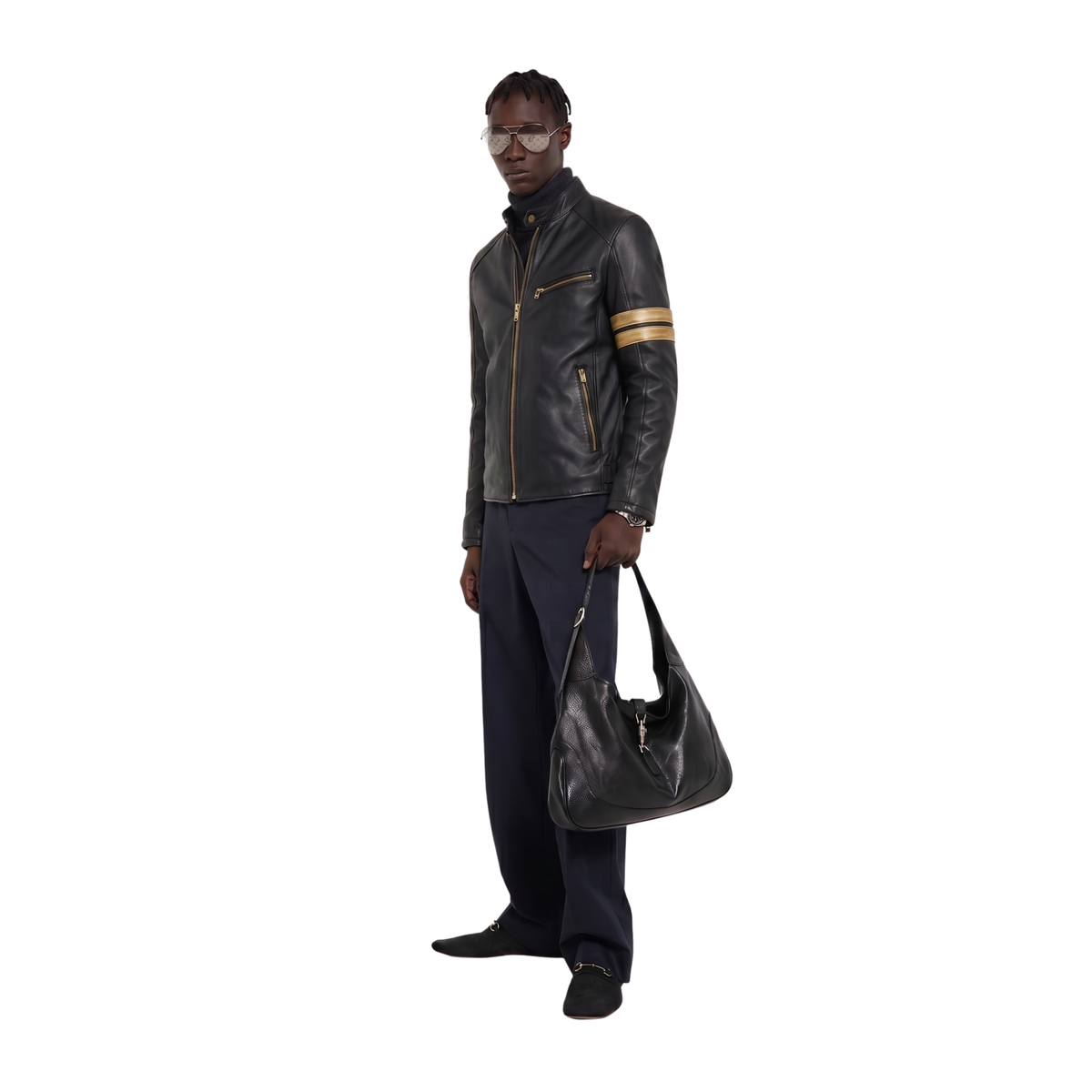 Men's black leather jacket with gold stripes, styled with navy pants and a matching leather bag