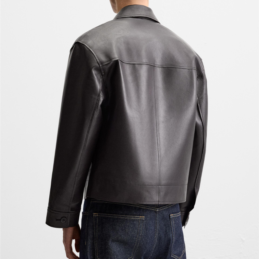 Men's black leather jacket back view, slim fit, paired with dark denim jeans