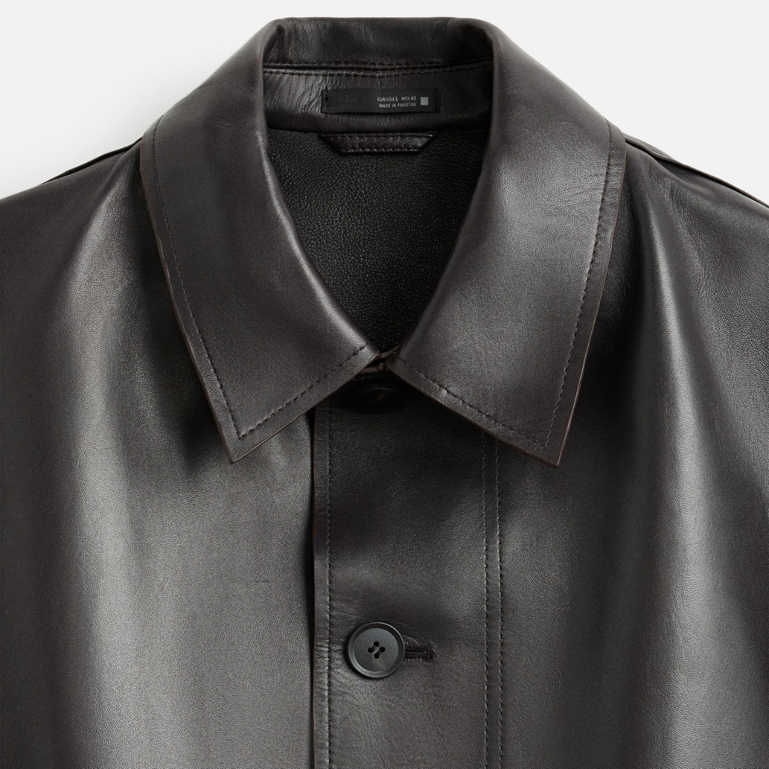 Black leather jacket with classic collar and button closure, sleek design for men
