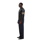 Man in black leather jacket with tan stripes, navy pants, and sunglasses, side profile