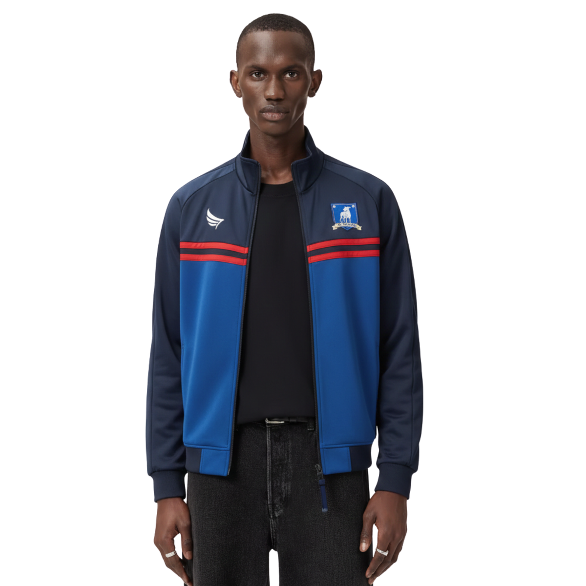 Men's navy and royal blue track jacket with red stripes and crest, styled with black tee and jeans