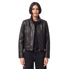Woman wearing black leather moto jacket with snap buttons and zipper, styled with dark jeans