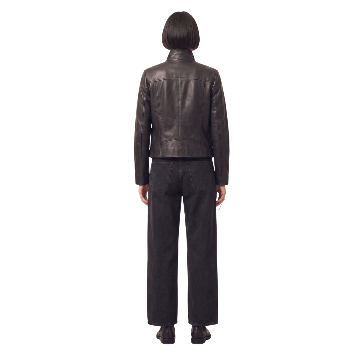 Woman wearing black leather jacket and wide-leg jeans, back view
