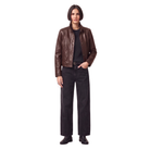 Woman wearing brown leather jacket, black jeans, and boots for stylish casual outfit