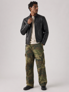 Man wearing black leather jacket and camouflage cargo pants for stylish casual look