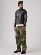 Men's black leather moto jacket with zipper pockets, paired with green camouflage cargo pants and black boots