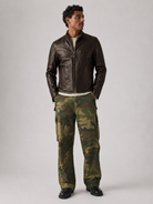 Man wearing brown leather jacket and camouflage cargo pants for stylish outdoor look