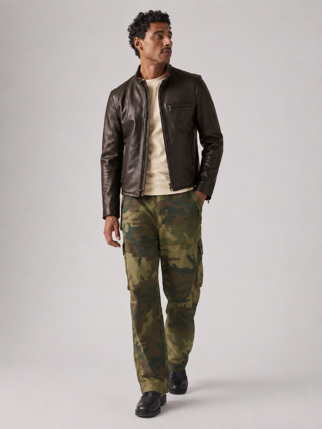 Man wearing brown leather jacket and green camouflage cargo pants, casual stylish outfit