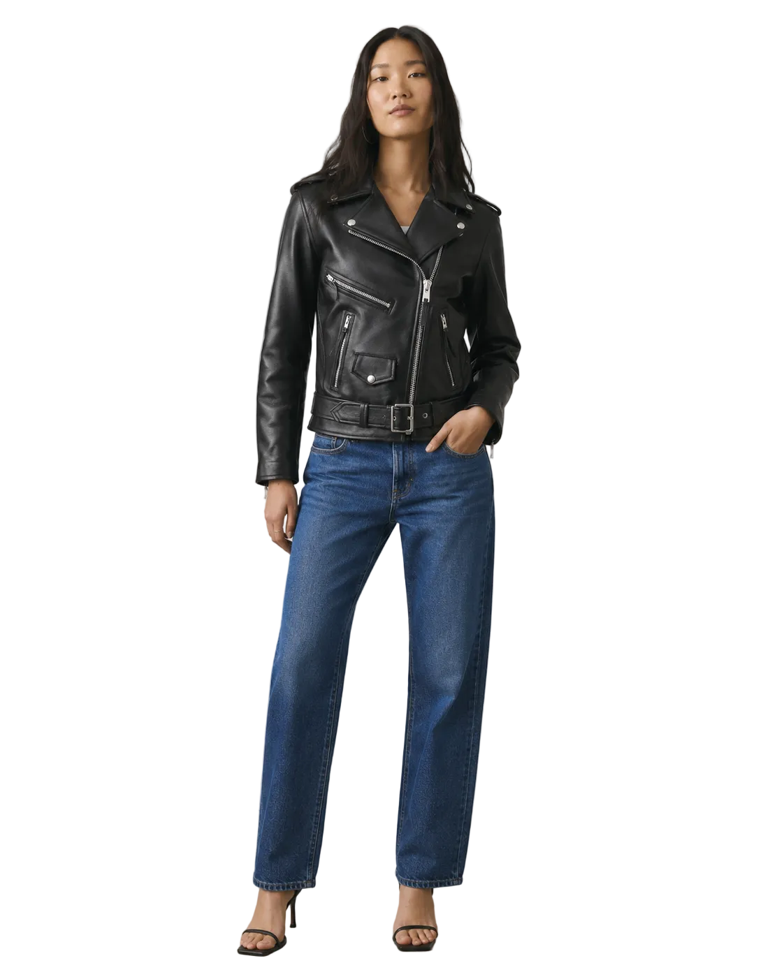 Woman wearing black leather moto jacket with belt, blue jeans, and heels