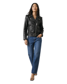 Woman in black leather moto jacket with belt, paired with blue jeans and heels
