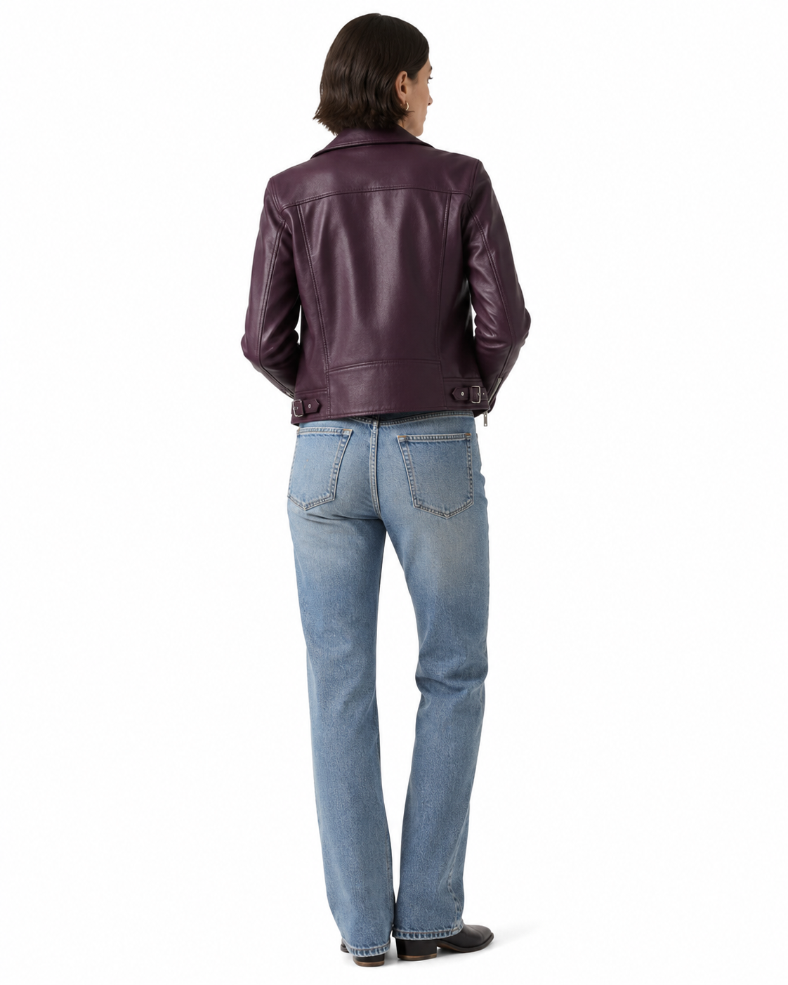 Woman wearing purple leather jacket and blue jeans, back view