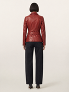 Red leather jacket with belt back view, paired with black wide-leg jeans and heels