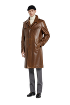 Men's brown leather trench coat with classic collar, front buttons, and pockets, styled with beanie and loafers