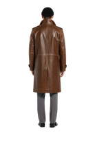 Men's brown leather trench coat with classic back view, paired with gray trousers and black beanie