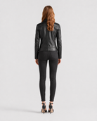Woman wearing black leather jacket and skinny jeans, back view