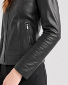 Black leather moto jacket with zipper pocket and ribbed sleeve detail