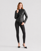 Woman in black leather moto jacket, skinny jeans, and bow heels