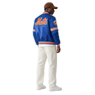 Blue Mets varsity jacket with orange lettering, striped cuffs, and team logo, worn with white pants and cap