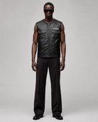 Men's black leather vest with Sons of Anarchy patch, paired with dark trousers and sunglasses