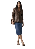 Woman in brown leather blazer, denim midi skirt, black heels, and matching handbag, studio fashion look