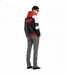 Men's black leather jacket with red bat logo, white panels, and hood, styled with gray pants and beanie