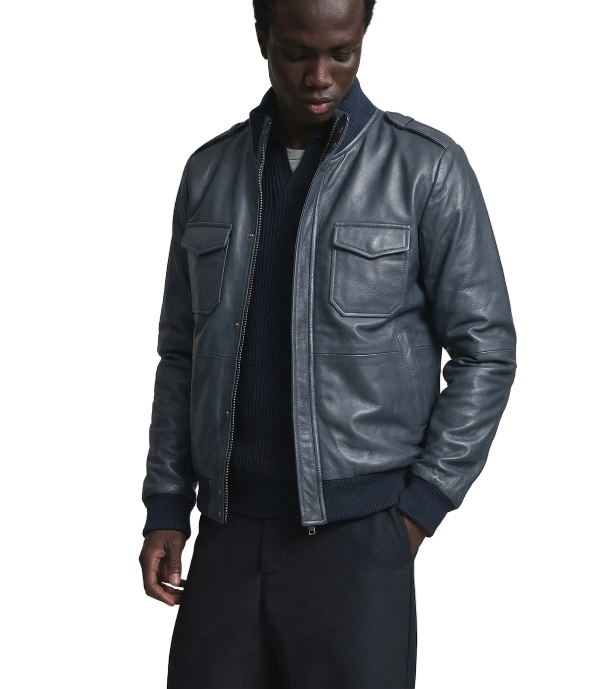 Men's dark gray leather bomber jacket with front pockets and ribbed cuffs, styled over a navy sweater