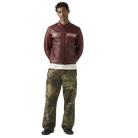 Man wearing burgundy Harley-Davidson leather moto jacket with camo cargo pants