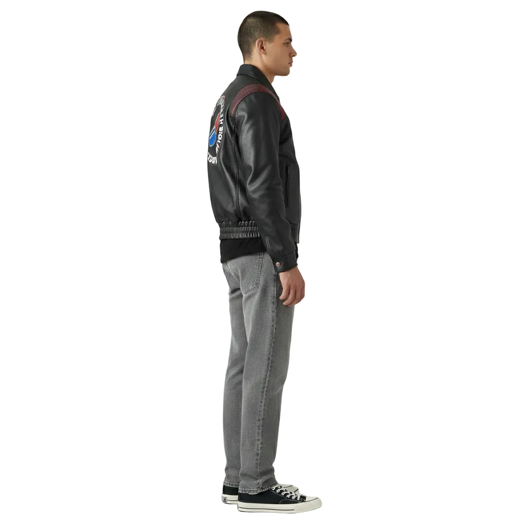 Men's black leather bomber jacket with patch, paired with gray jeans and sneakers
