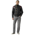 Men's black leather jacket with burgundy shoulder panels and gold hardware, styled with gray jeans and sneakers