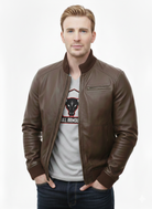Man wearing brown leather bomber jacket with ribbed collar, zipped front, and chest pocket, paired with graphic tee and jeans