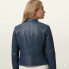 Blue leather jacket with back seam detailing, worn by woman in side profile