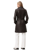 Black leather trench coat with belt, worn with white pants and sneakers, back view