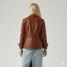 Brown leather jacket with buckle cuffs, back view on woman with blonde hair