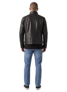 Men's black leather moto jacket with quilted shoulders, back view, paired with blue jeans and sneakers