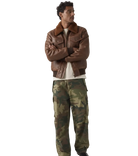Men's brown leather bomber jacket with shearling collar paired with camouflage cargo pants
