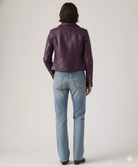 Purple leather moto jacket with zipper details, paired with light wash denim jeans, back view