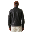 Men's black leather jacket back view with brown cap and cream pants