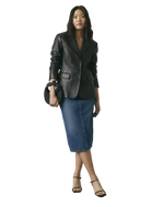 Woman wearing black leather blazer, denim midi skirt, and black heels with a matching handbag.