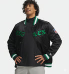 Men's black Eagles varsity jacket with green lettering and NFL patch, featuring ribbed collar and cuffs