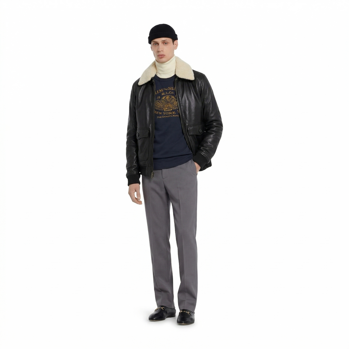Men's black shearling collar leather jacket with graphic tee, gray trousers, and loafers
