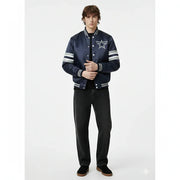 Navy blue varsity jacket with star logo and striped sleeves, paired with black jeans