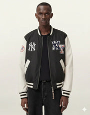 Black and white varsity jacket with NY logos, worn over black shirt and jeans